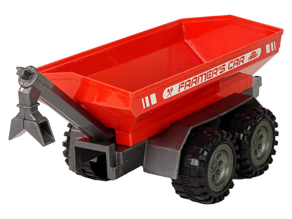 Trator verde com reboque vermelho fricção