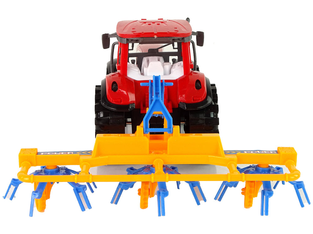 Trator vermelho com ancinho fricção